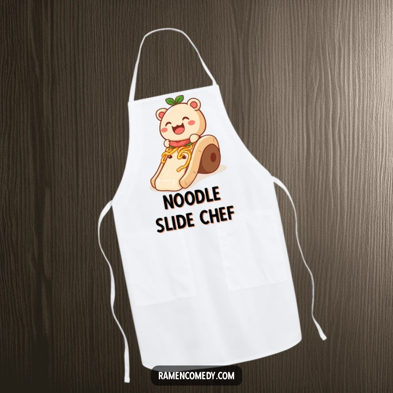 Funny Apron: A smiling bao bun hilariously slides down a noodle slide, ideal for a humorous cooking experience.