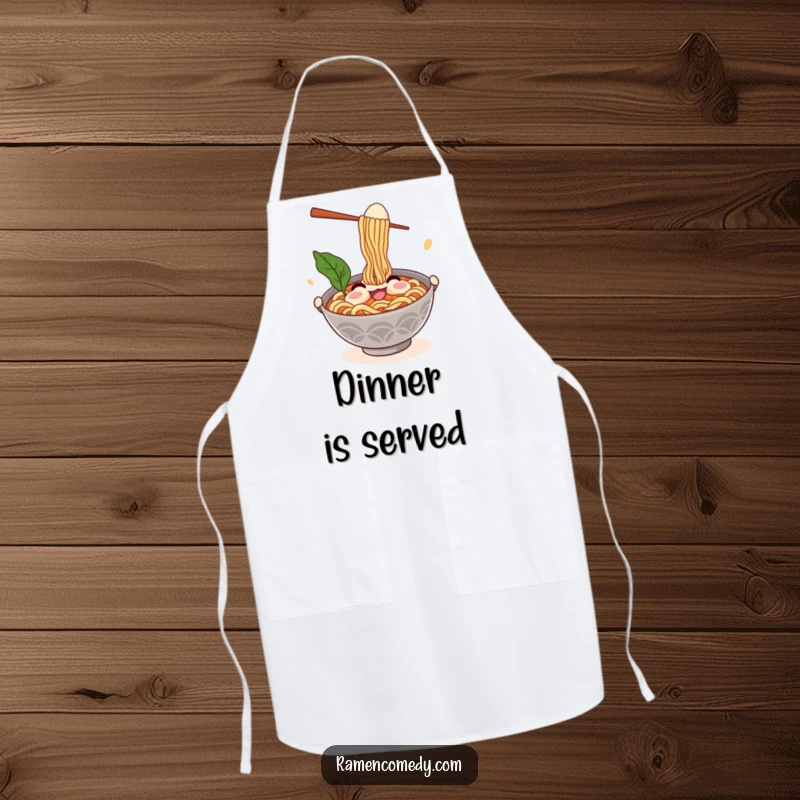 Funny ramen apron showing a smiling noodle bowl character comically juggling chopsticks and an egg, ideal for culinary fun.