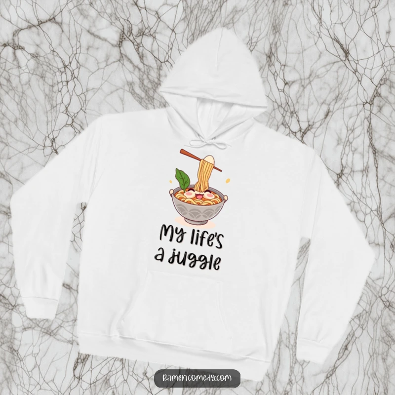 Funny ramen hoodie showcasing a smiling noodle bowl character comically juggling chopsticks and an egg, offering warmth and humor.