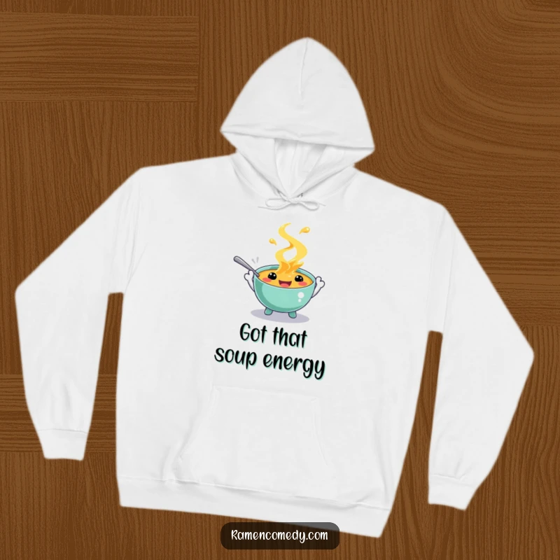 Funny hoodie showcasing a happy soup character with spoon hands, splashing gleefully. Comfortable and amusing apparel for chilly days.