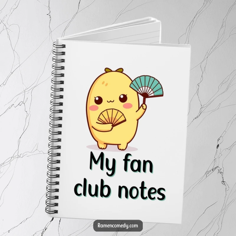 Funny tamagoyaki character holding a tiny fan on a notebook, perfect for jotting down delightful thoughts.
